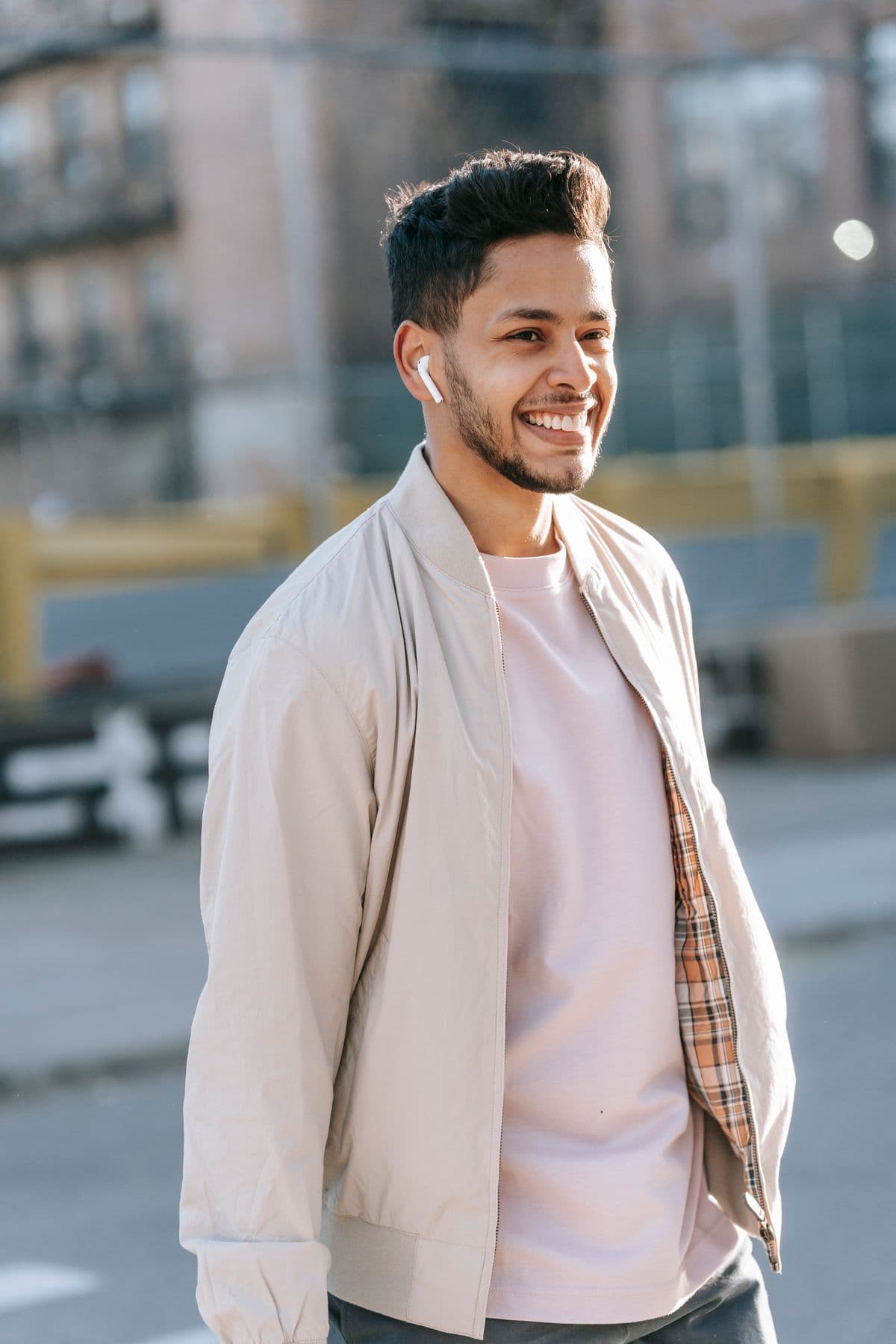 a smiling young man on a city street