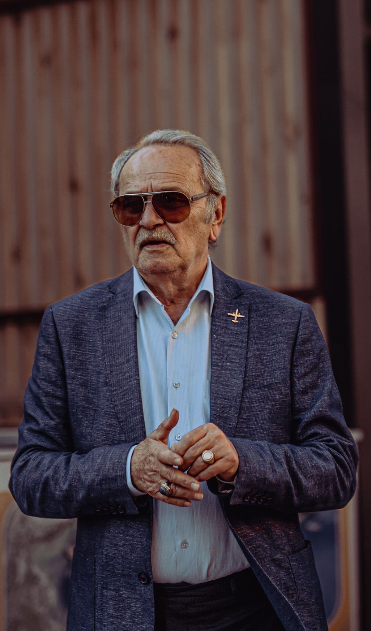 an older man in a blazer and sunglasses